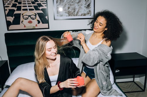 Two Young Women Putting Hair Rollers on Their Hair