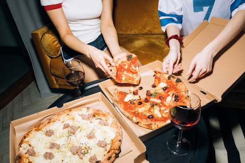 Free Two Person Getting a Slice of Pizza Stock Photo