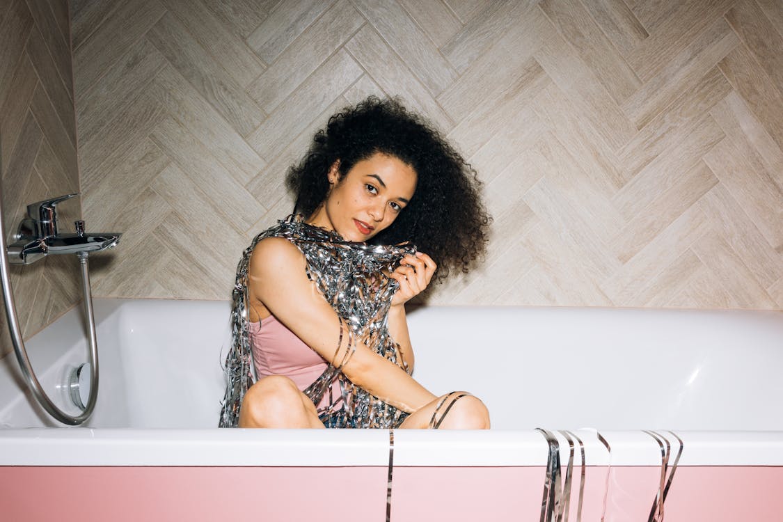 Girl Smiling While Sitting in a Bathtub