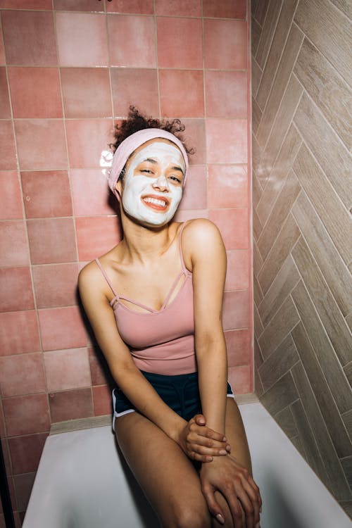 Girl Smiling While Sitting on a Bathtub