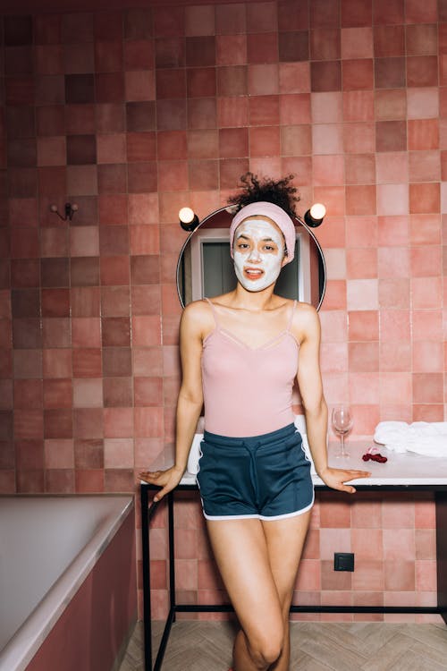 Free Girl Smiling While Standing by the Sink Stock Photo