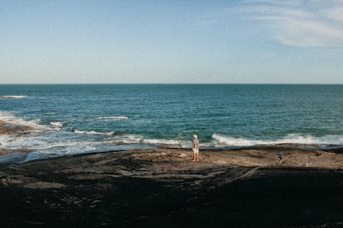 Free A Man Standing on a Beach Stock Photo