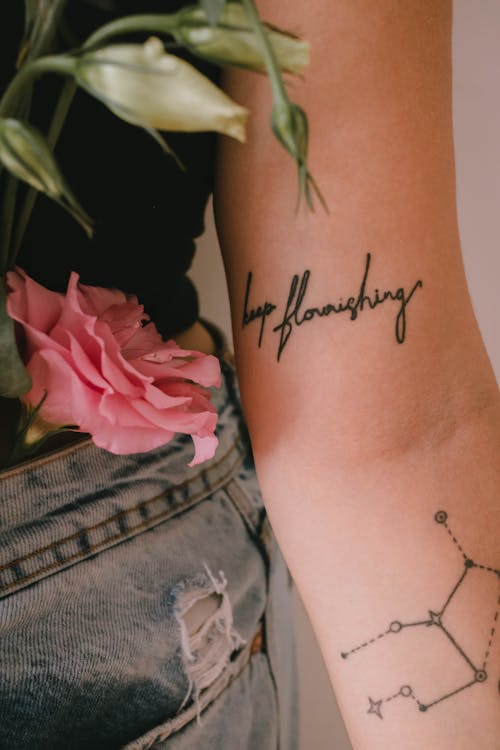 A Rose Beside a Person's Tattoo