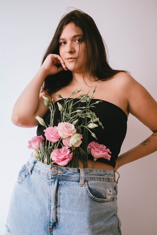 Woman in Black Tube Top with Fresh Flowers on her Waist