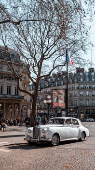 Classic Rolls Royce on a Paris street, capturing urban elegance and vintage charm.