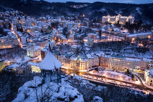 Aerial Shot of Town Covered with Snow Illuminated at Night