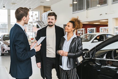 Free Couple Buying Car in Dealership Stock Photo