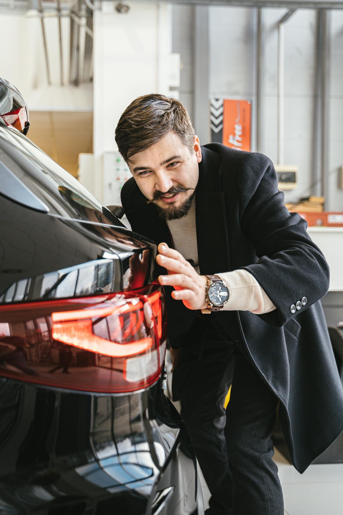 EV technician working on electric vehicle battery module in professional workshop environment