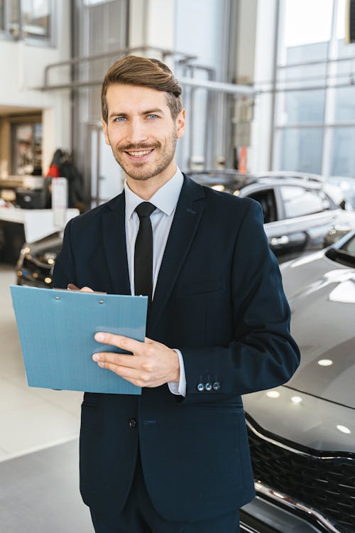Free Man in Blue Business Suit Holding Blue Folder Stock Photo