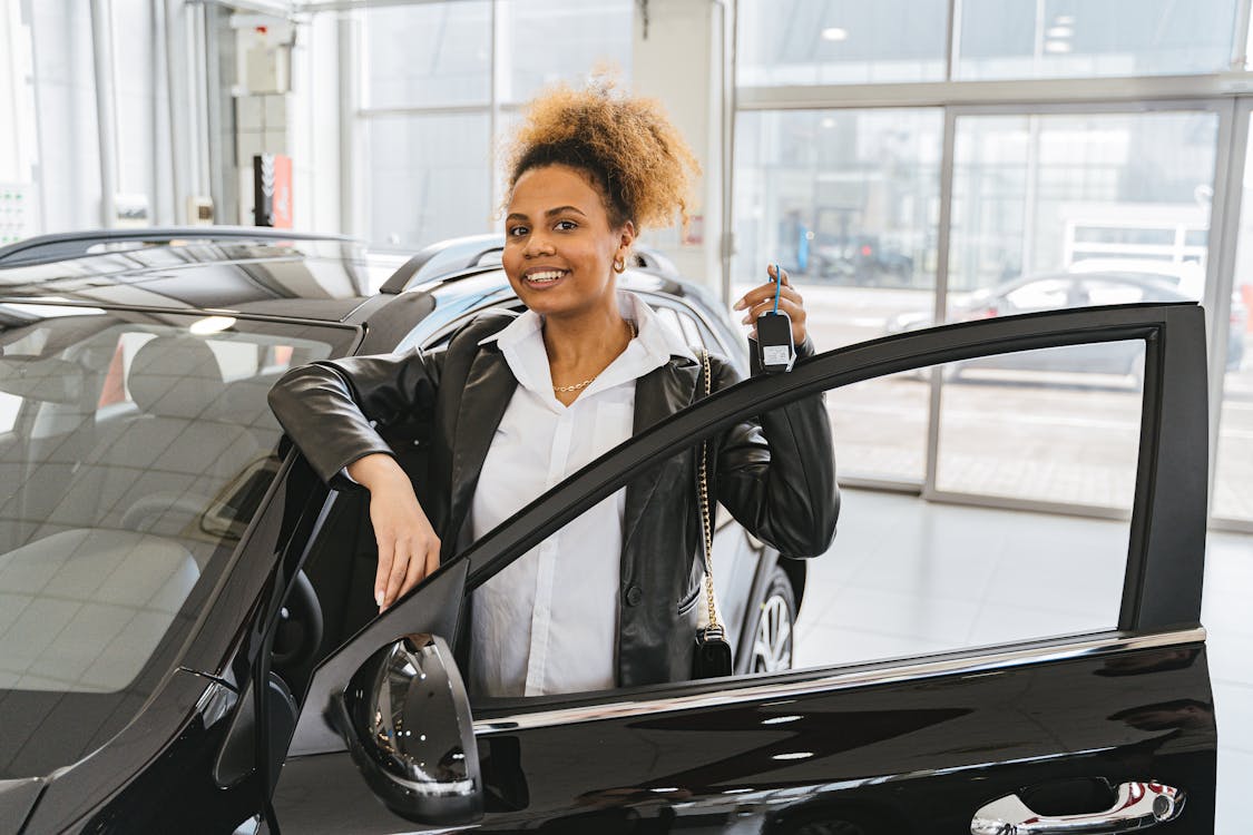 Free Woman in Black Blazer Standing Beside Black Car Stock Photo best time to lease a car