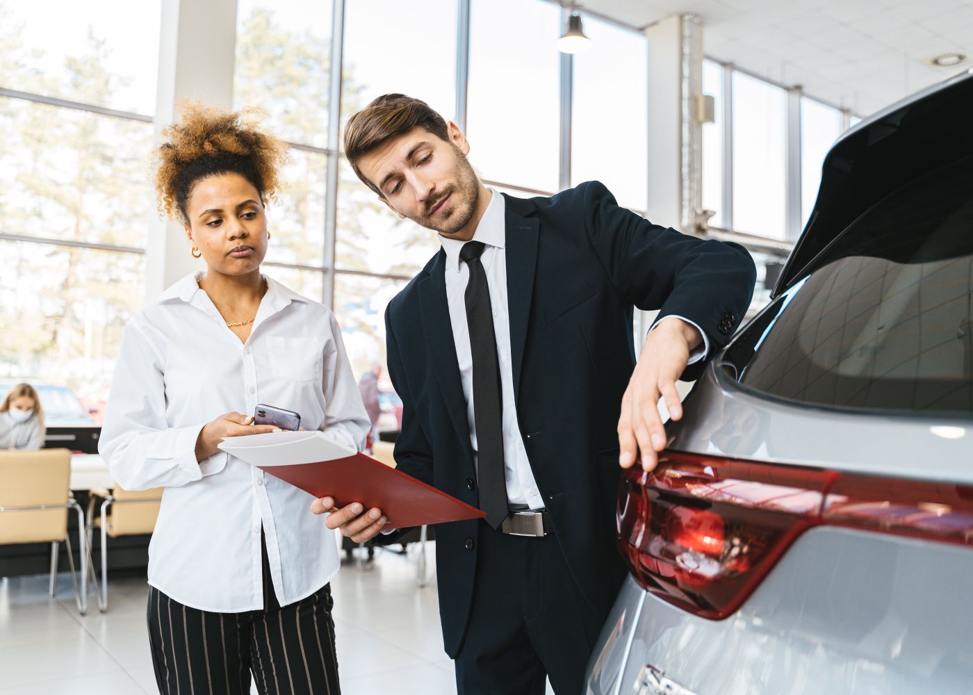 Vault Motors advisor reviewing a customer's vehicle for trade-in