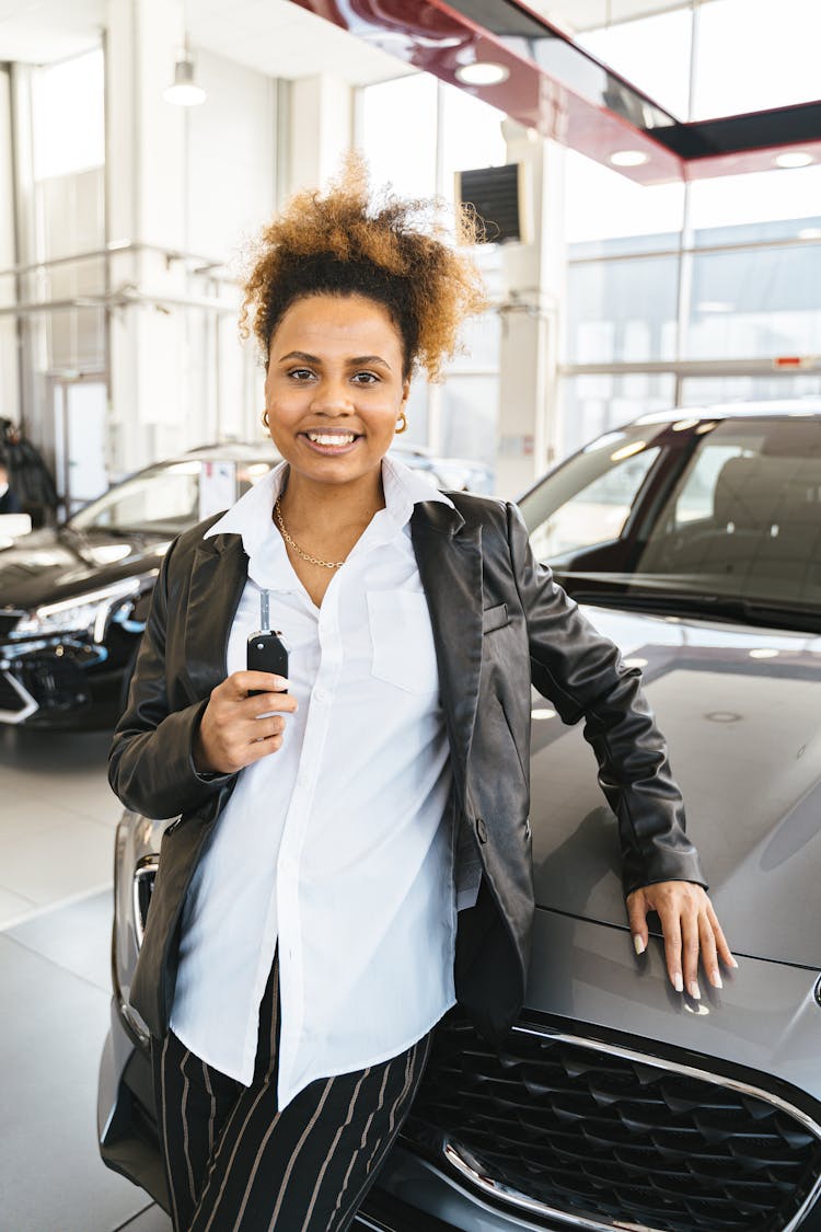 A Woman Holding A Car Key 