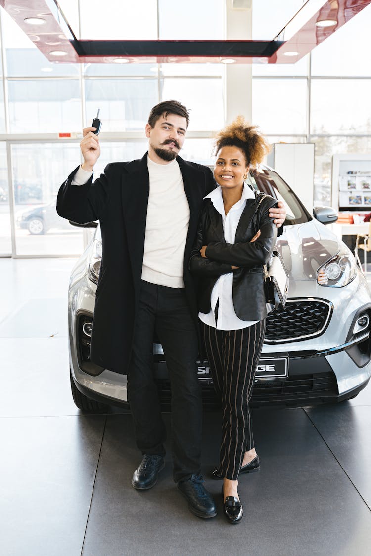 A Man Holding A Car Key 