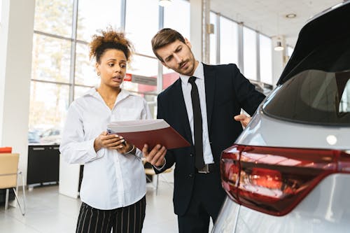 Free A Woman Talking to a Car Dealer  Stock Photo