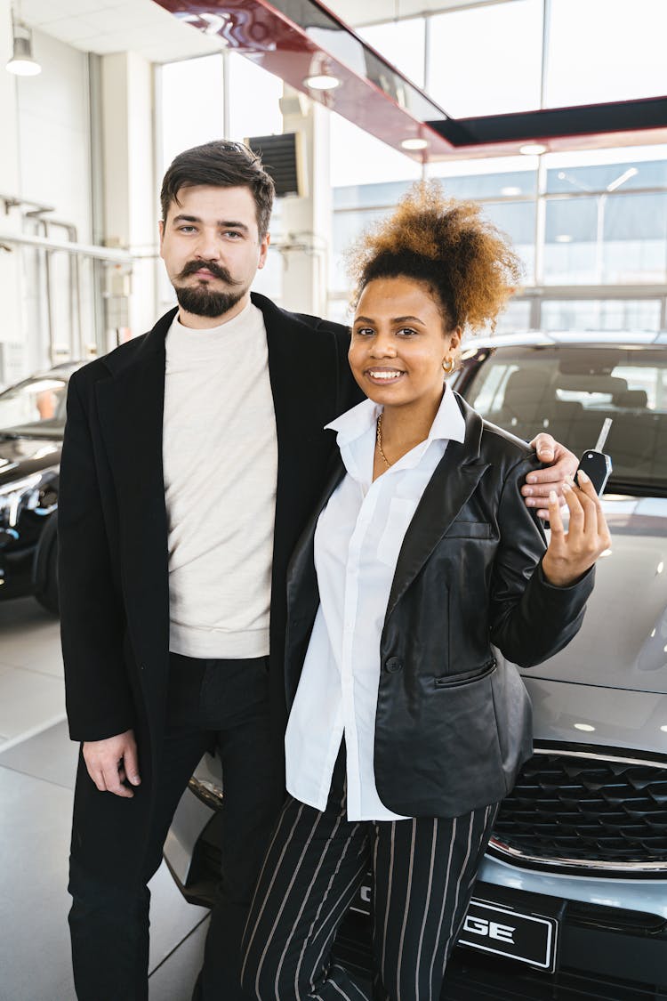 Photo Of A Woman Holding A Car Key Beside A Man