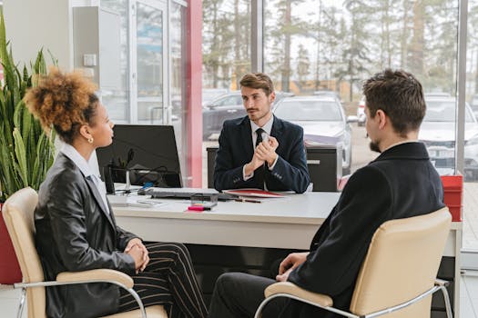 Professional meeting with clients at a modern office, discussing business solutions.