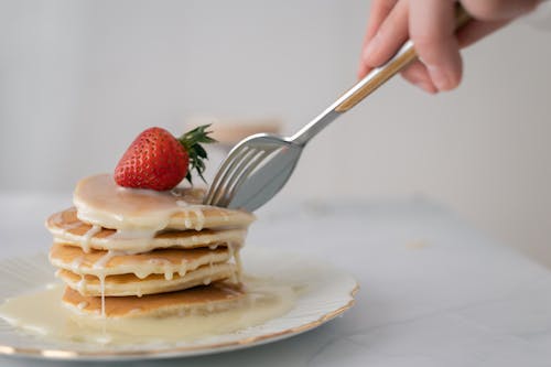 A Plate with Pancakes and a Strawberry