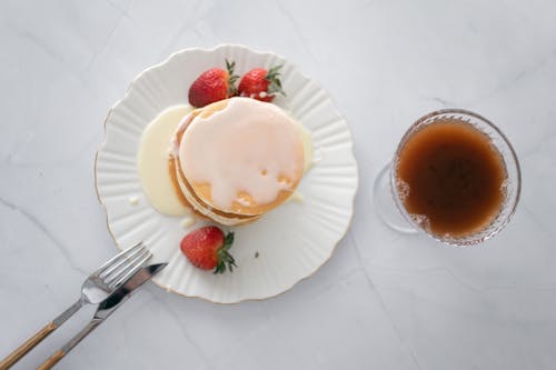 Overhead Shot of a Plate with Pancakes and Strawberries