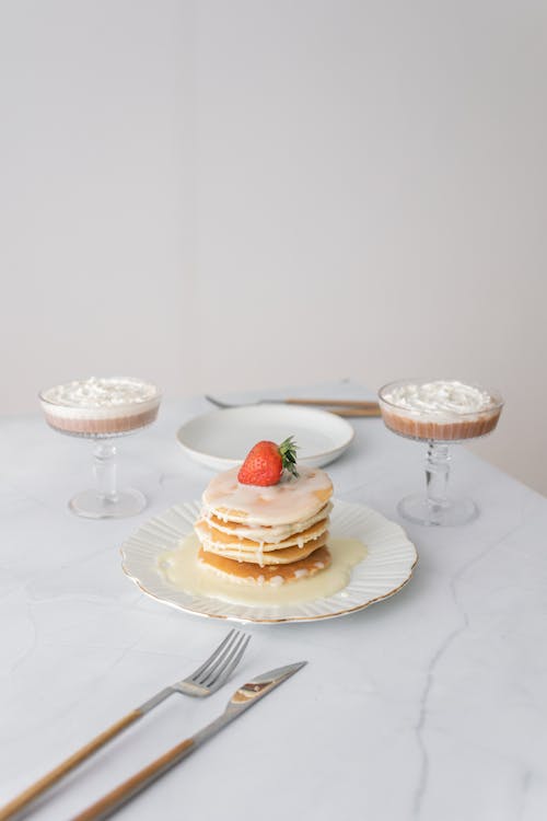 Free Glasses with Mousse Near a Stack of Pancakes Stock Photo