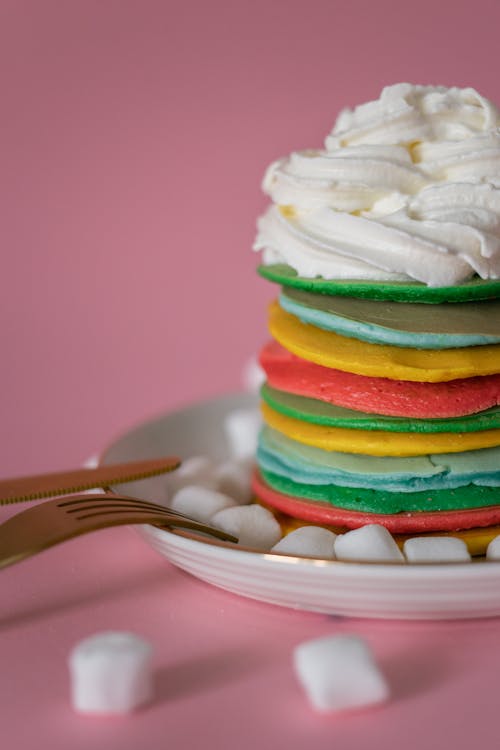 Dessert with bright pancakes covered with delicate cream