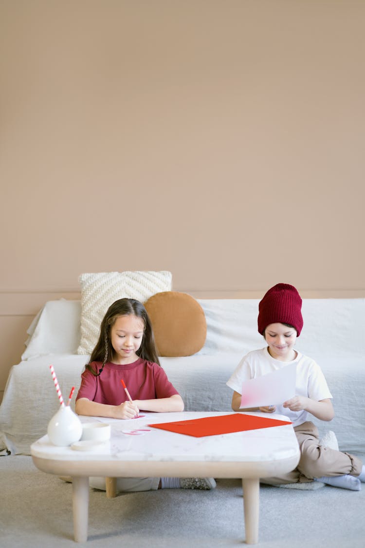 A Girl And A Boy Playing With Art Materials