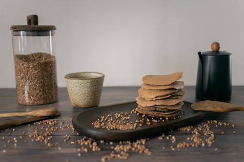 Homemade buckwheat pancakes placed on table with ingredients and utensils