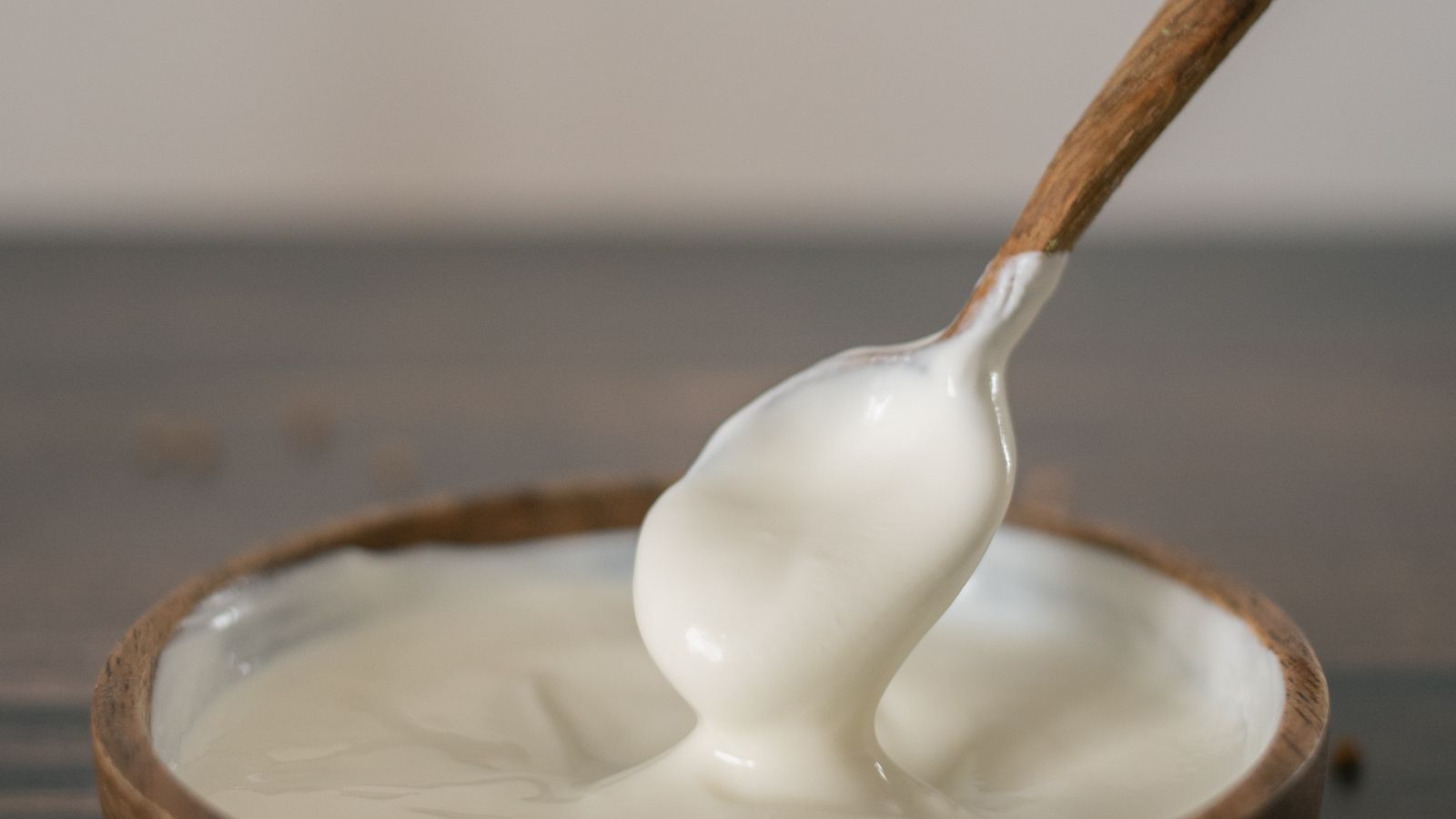 Sour cream in a rustic wooden bowl with a wooden spoon — photo by Monstera Production on Pexels Sour cream in a rustic wooden bowl with a wooden spoon
