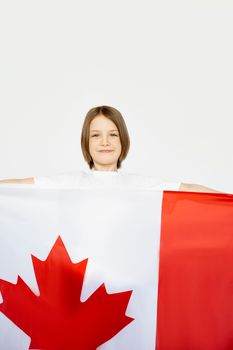 Young girl proudly holding a Canadian flag, symbolizing national pride and celebration.