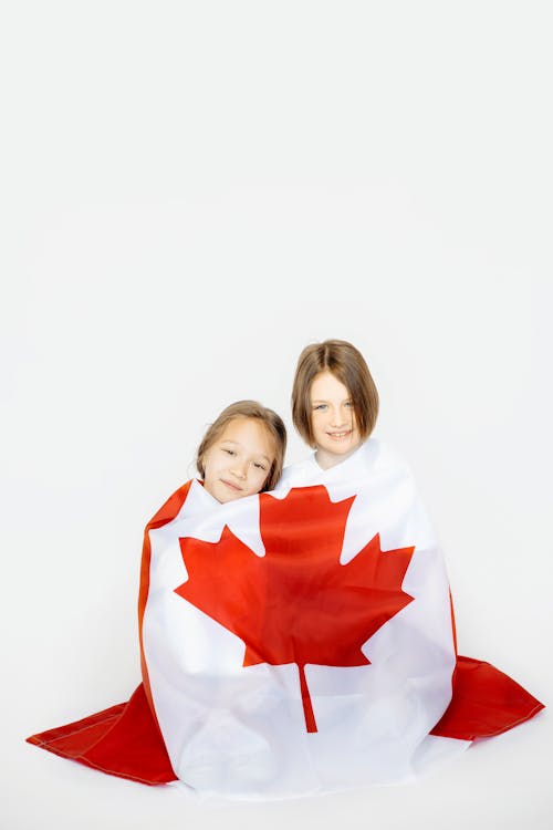 Free Two Girls Wrapped in Canadian Flag Stock Photo