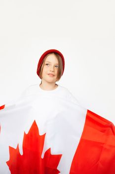 Happy child celebrating Canada Day holding a Canadian flag, symbolizing patriotism and joy.