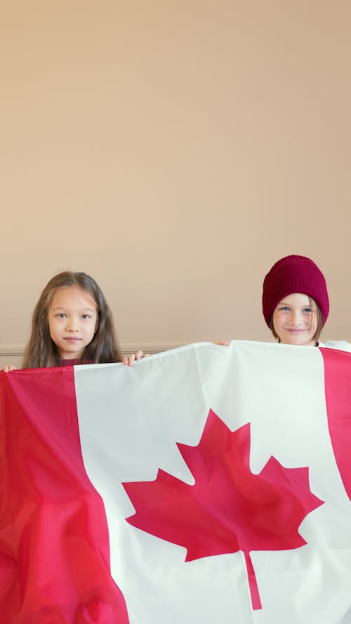 Kids Holding Red and White Flag