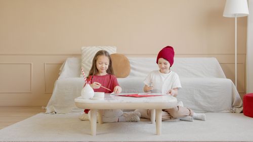 Free Two kids enjoying arts and crafts together indoors, enhancing creativity and bonding. Stock Photo