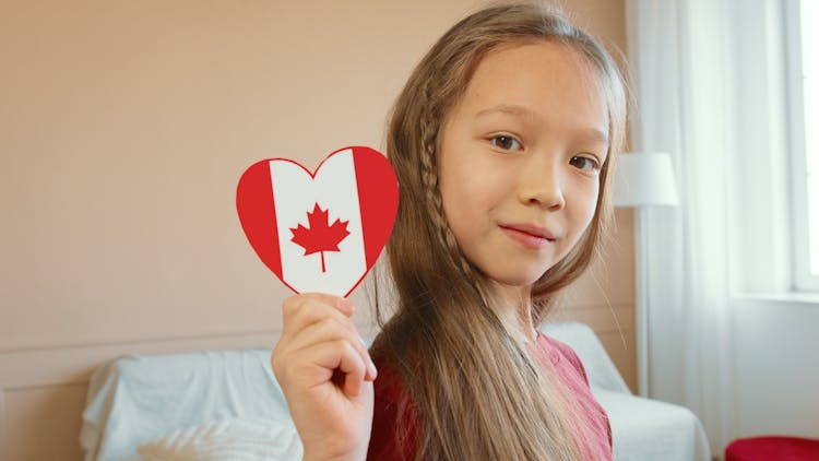 A Girl Holding A Paper Heart