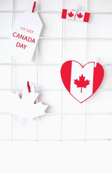 Canadian flag and maple leaf decorations celebrating Canada Day on a white backdrop.