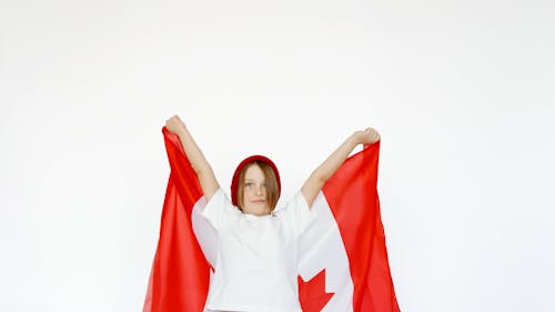 A Child Holding a Canada Flag