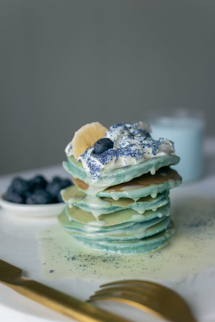 Close-Up Shot Of Green Pancake With Cream