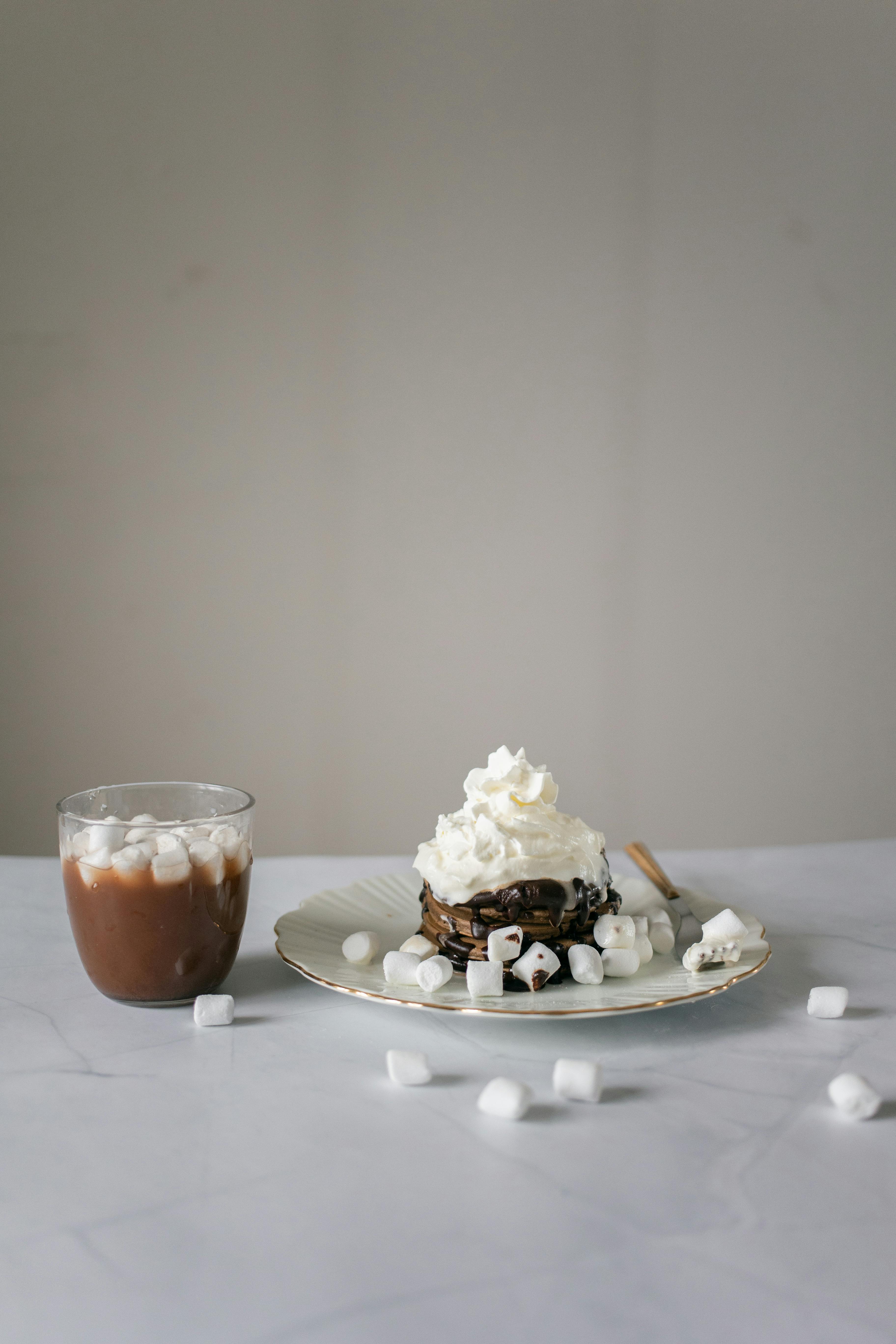 chocolate pancake with marshmallows near glass of chocolate