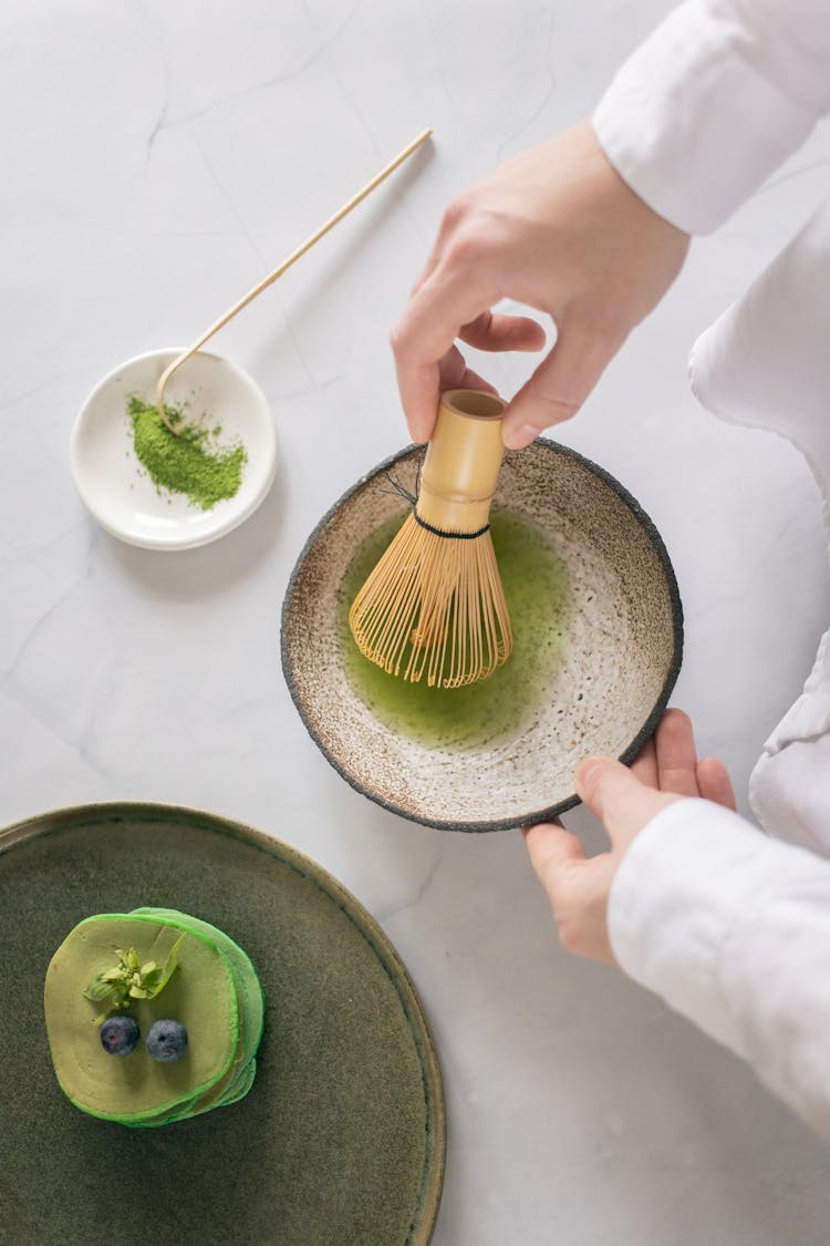 Crop Person Preparing Green Food Coloring With Matcha Powder