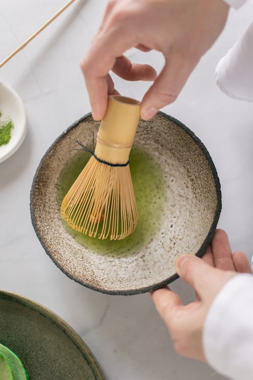 Sip & Savor: Your Ultimate Guide to Matching Up with Matcha Delights 1 Person preparing ingredients using whisk
