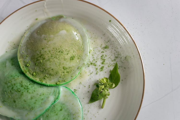 Poached Egg With Seasoning And Herb On Plate On Table