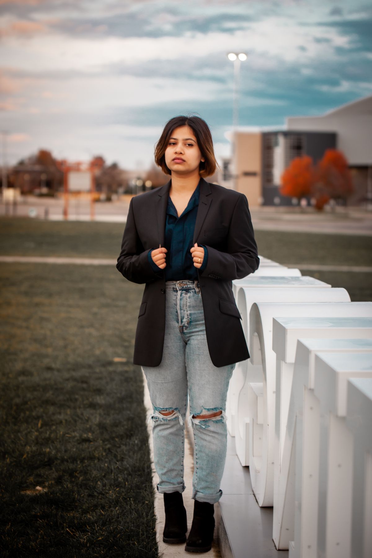 Woman styled in a black blazer over jeans