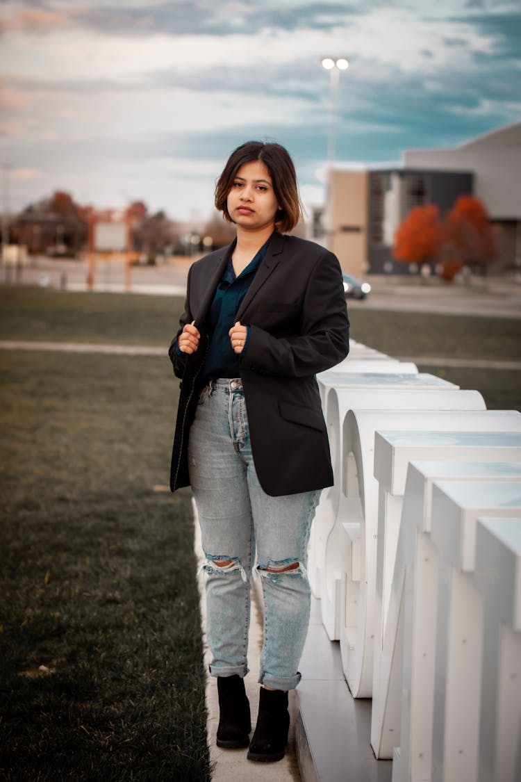 Female Standing While Holding Her Black Blazer