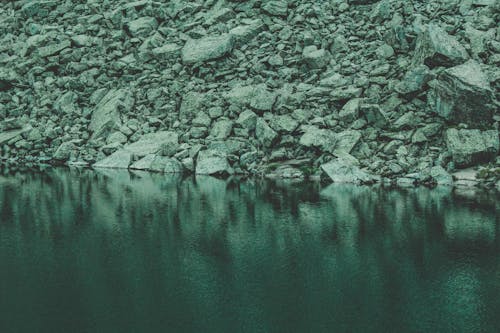 Free Rocks Near Calm Body Of Water Stock Photo