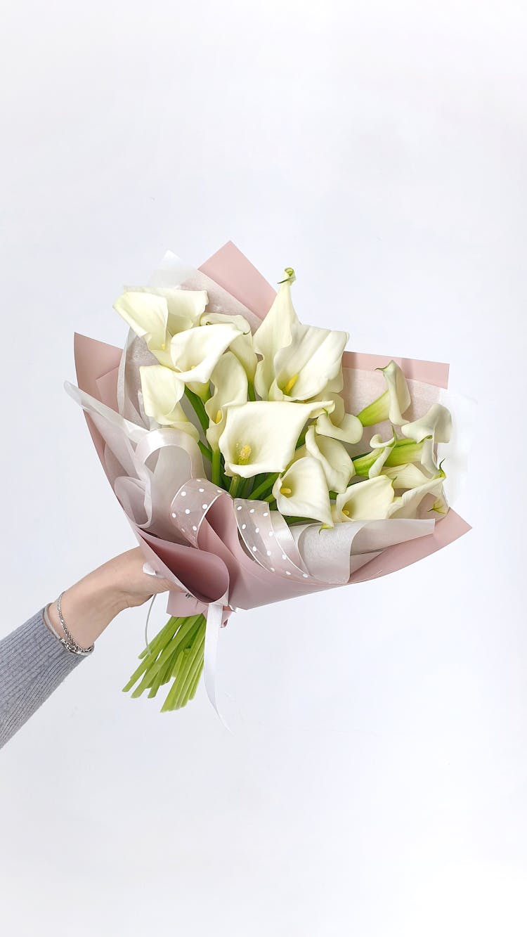 Faceless Woman Hand With Calla Lilies Bouquet In Paper