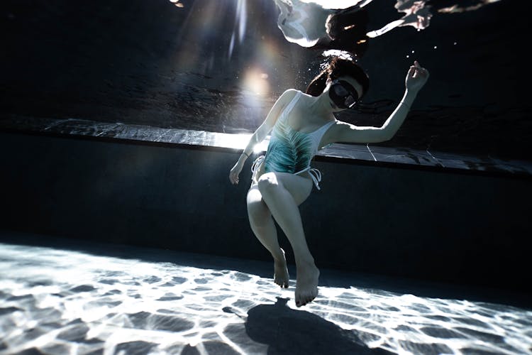 Woman In Mask Diving In Swimming Pool