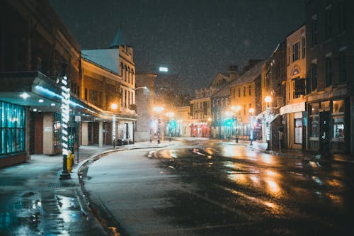 Street with asphalt road and buildings in winter