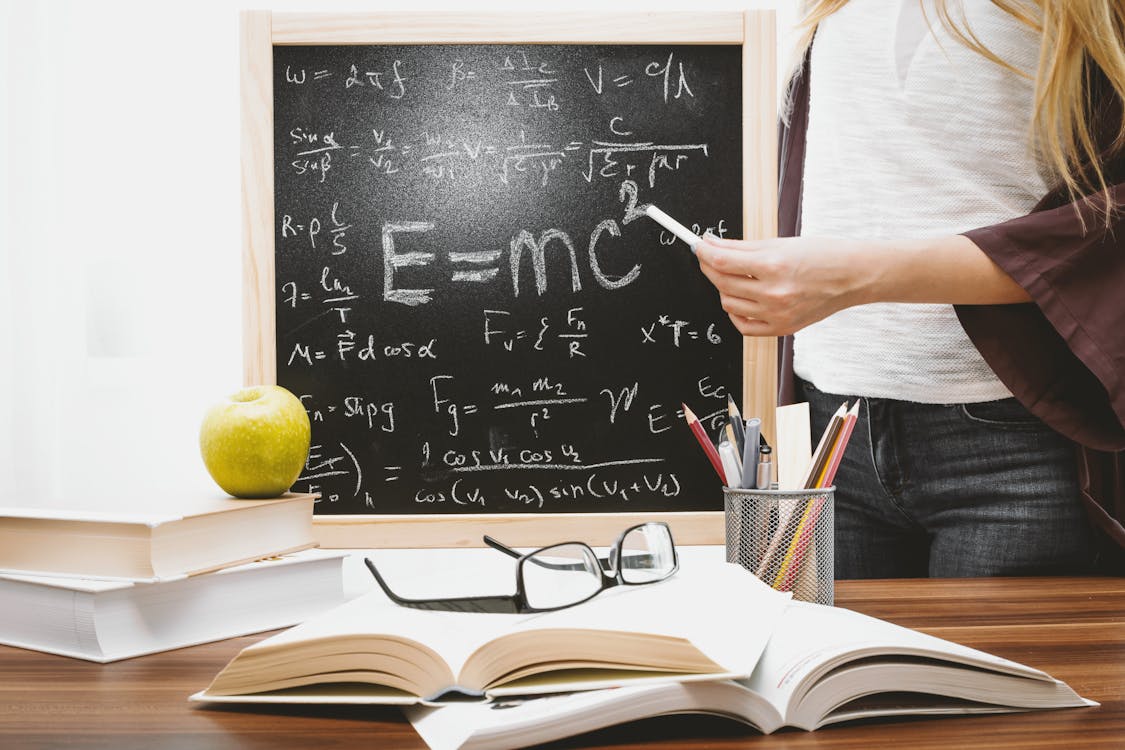 Free Woman Illustrating Albert Einstein Formula Stock Photo