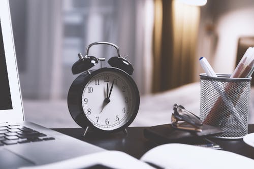 Free Black Twin Bell Alarm Desk Clock on Table Stock Photo