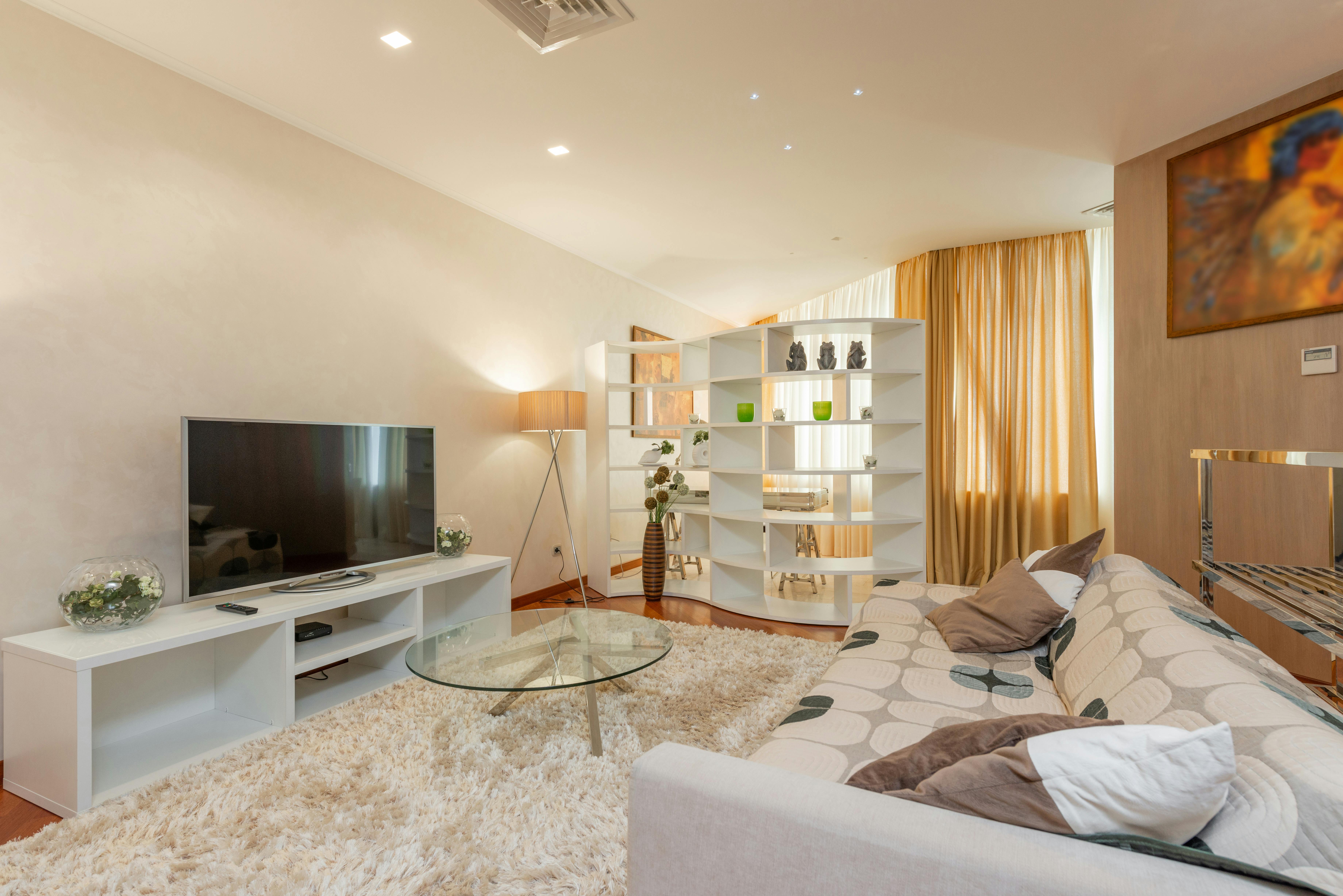 interior of modern living room with tv on cabinet on cozy couch