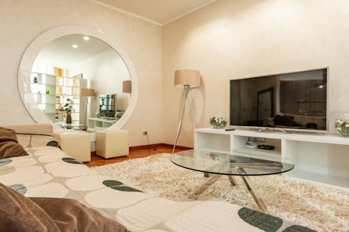 Free Interior of modern living room with round shaped mirror and couch with pattern Stock Photo
